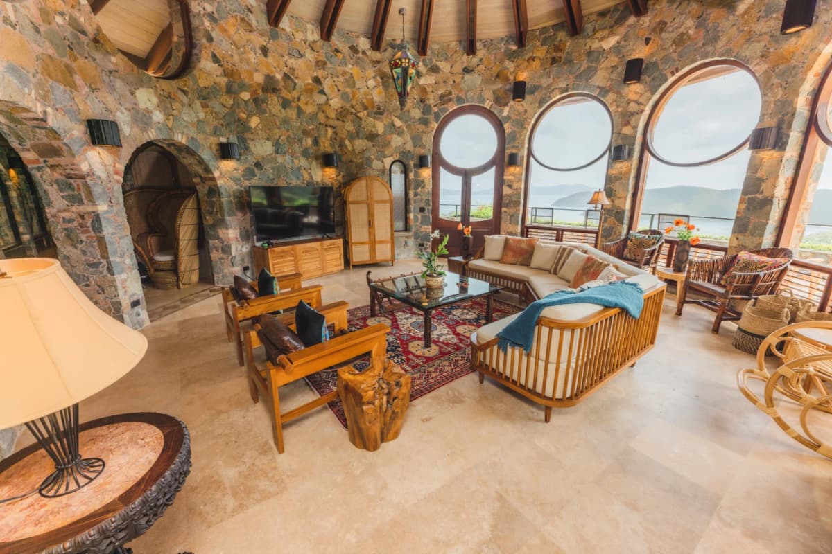 Grand living room with round windows and Balinese teak furniture at Valhalla St John