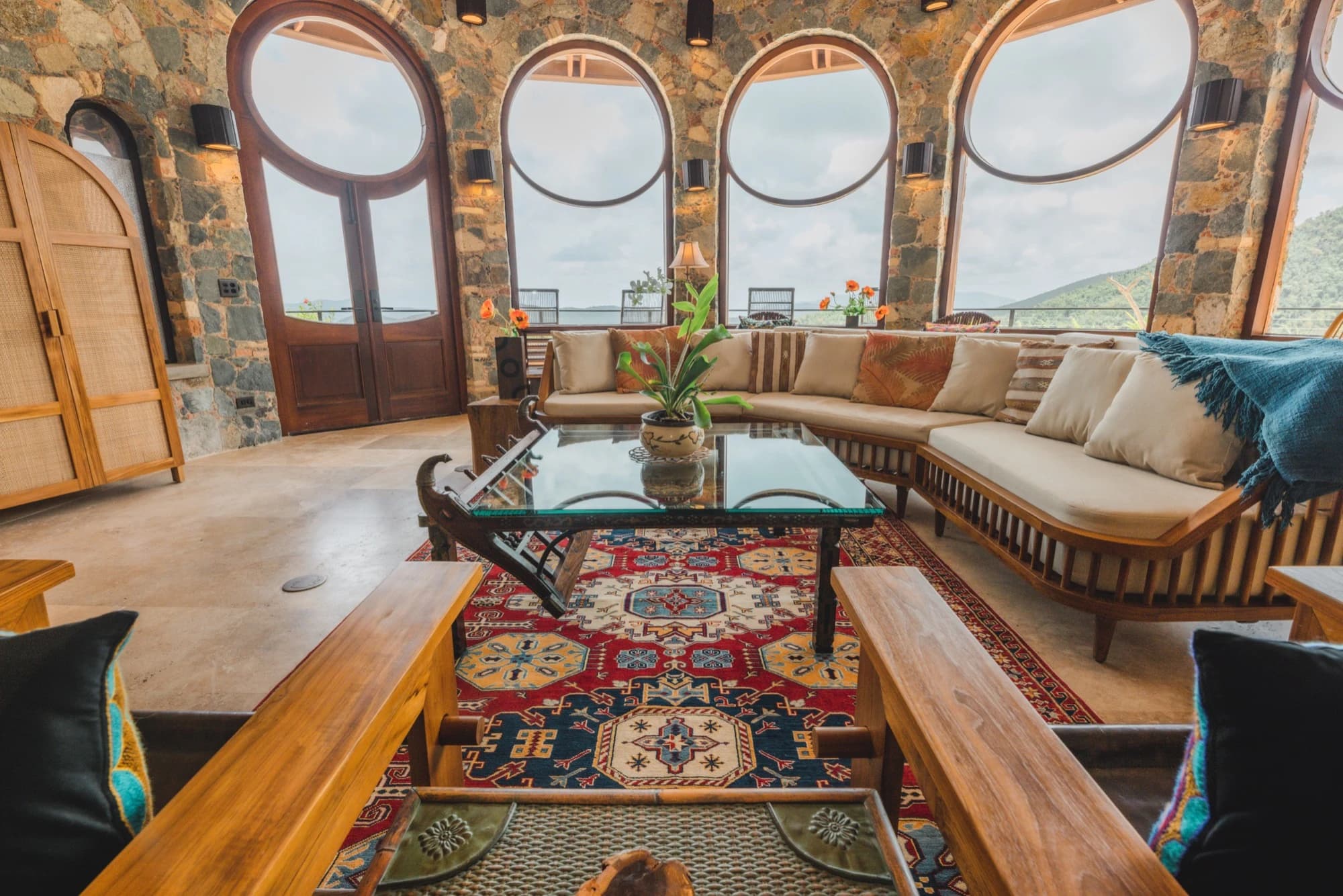 Living room with area rugs and arched stone details at Valhalla St John villa