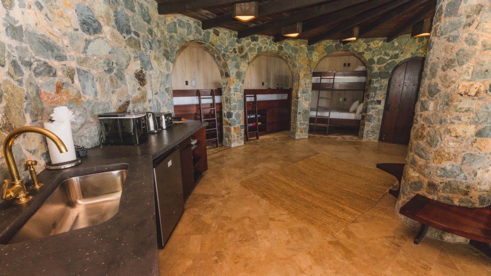Bunk room with kitchenette and arched alcoves at Valhalla St John, St. John USVI