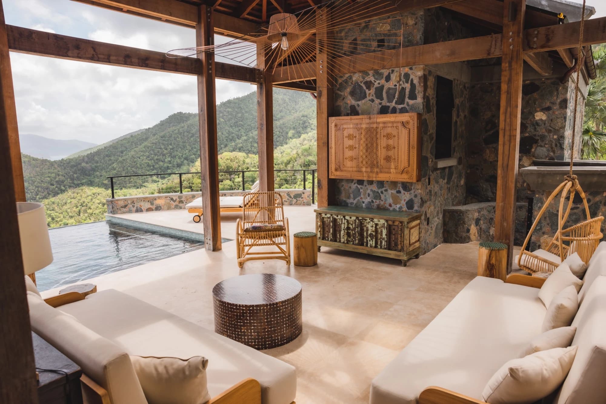 Outdoor living room with pool and mountain views at Valhalla St John
