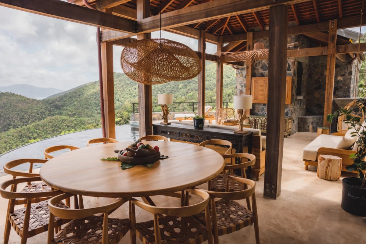 Covered outdoor dining for 10 with pendant light overlooking the pool at Valhalla St John